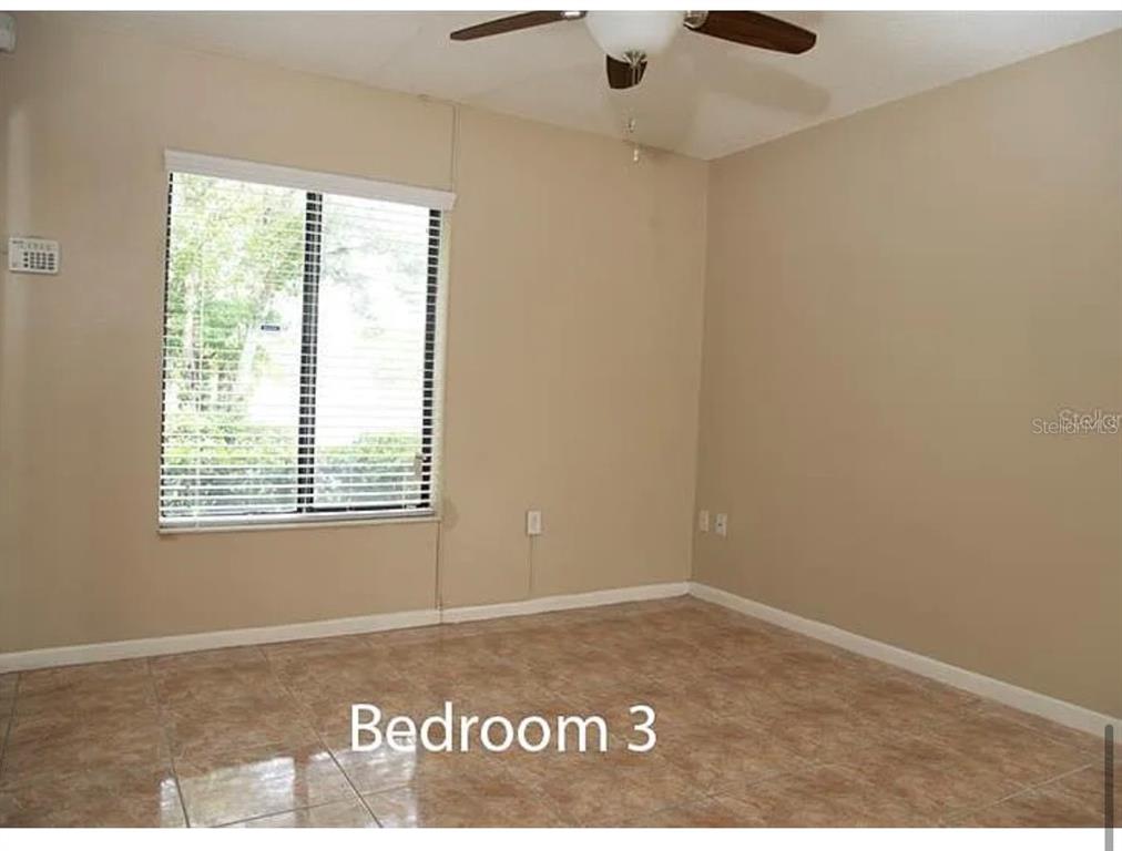1724 Pine Ridge Way West, Unit B1 Palm Harbor, FL 34684 - Photo 6 of 12 a view of an empty room and window