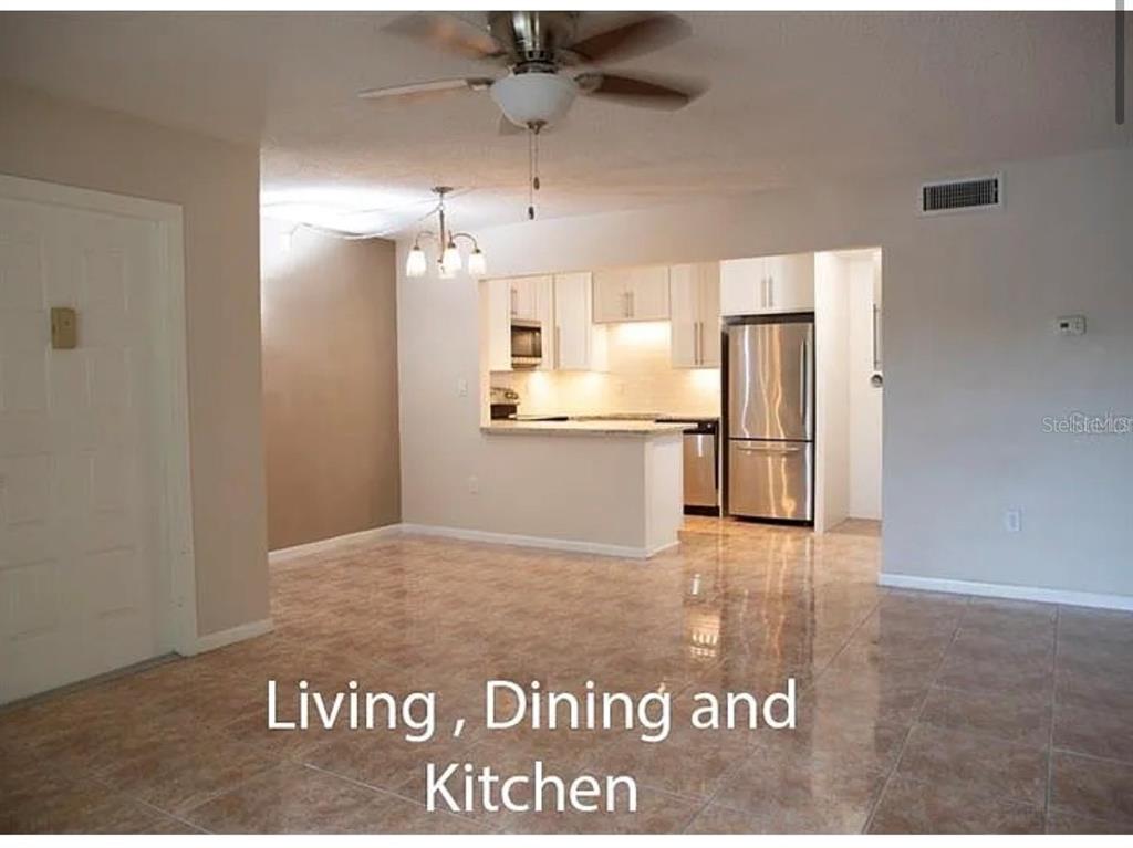 1724 Pine Ridge Way West, Unit B1 Palm Harbor, FL 34684 - Photo 7 of 12 a view of kitchen with refrigerator and microwave