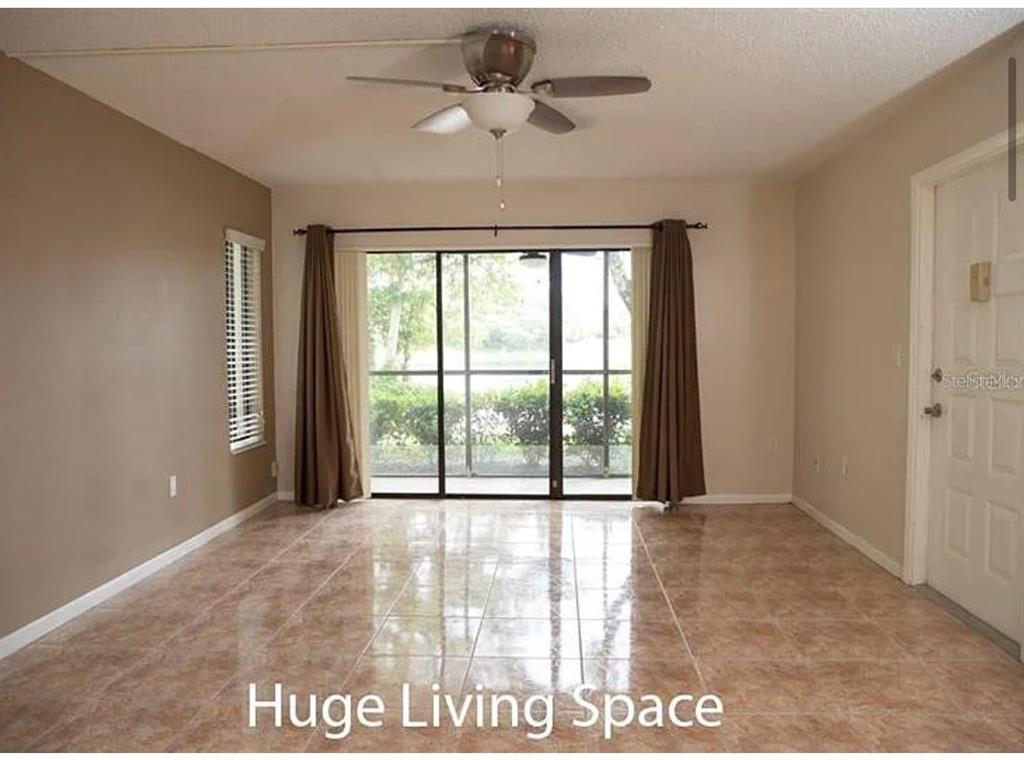 1724 Pine Ridge Way West, Unit B1 Palm Harbor, FL 34684 - Photo 10 of 12 a view of an empty room with a window