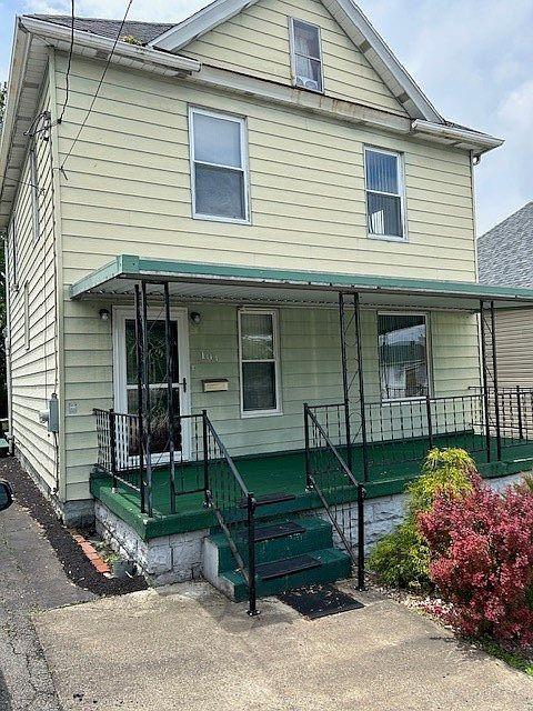 a view of a house with a yard and sitting area