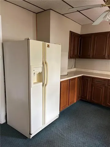 a view of hall with wooden floor and a fireplace