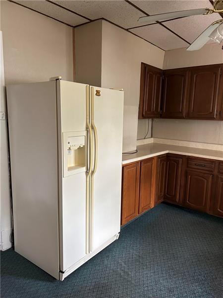 104 Whyle Avenue Uniontown, PA 15401 - Photo 6 of 12 a white refrigerator freezer sitting in a kitchen