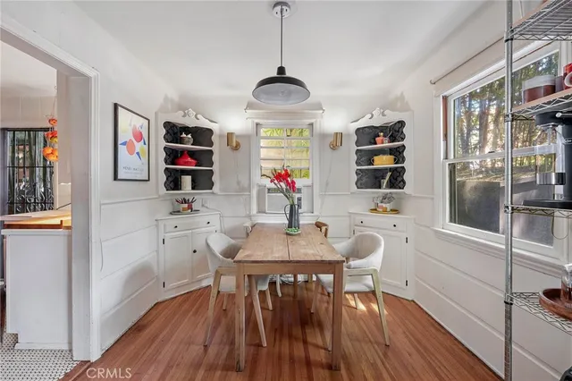a view of a dining room with furniture wooden floor and window