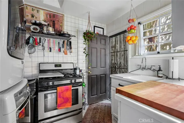 a kitchen with stainless steel appliances granite countertop a stove and a sink