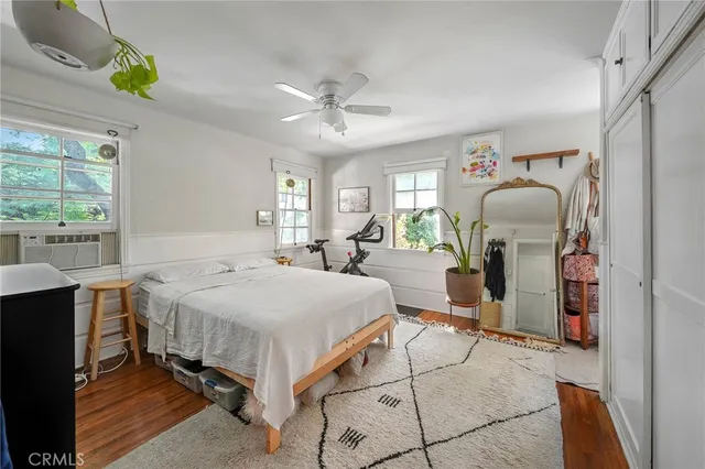 a spacious bedroom with a bed dresser and a window