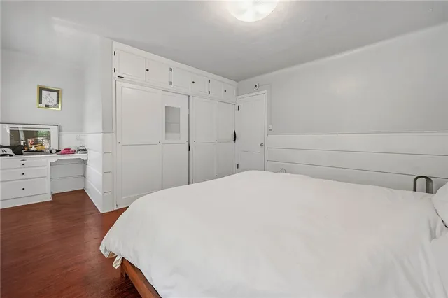 a workspace with furniture a potted plant and wooden floor