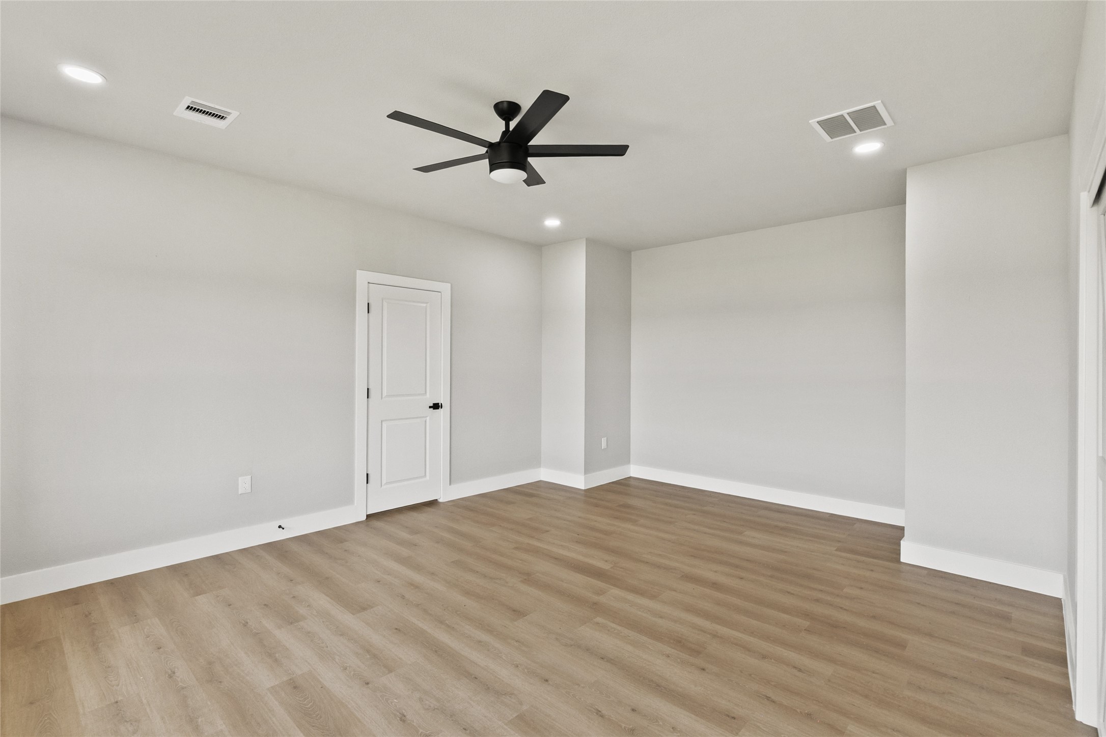 619 Chuckwagon Trail Angleton, TX 77515 - Photo 19 of 37 Relaxing primary suite with backyard views and a spa-inspired en suite bath featuring a fully tiled wet room, soaking tub, dual shower heads, double vanities, and a private water closet. The spacious walk-in closet includes built-in drawers for added organization.
