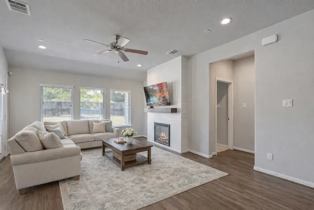 a living room with furniture and a fireplace