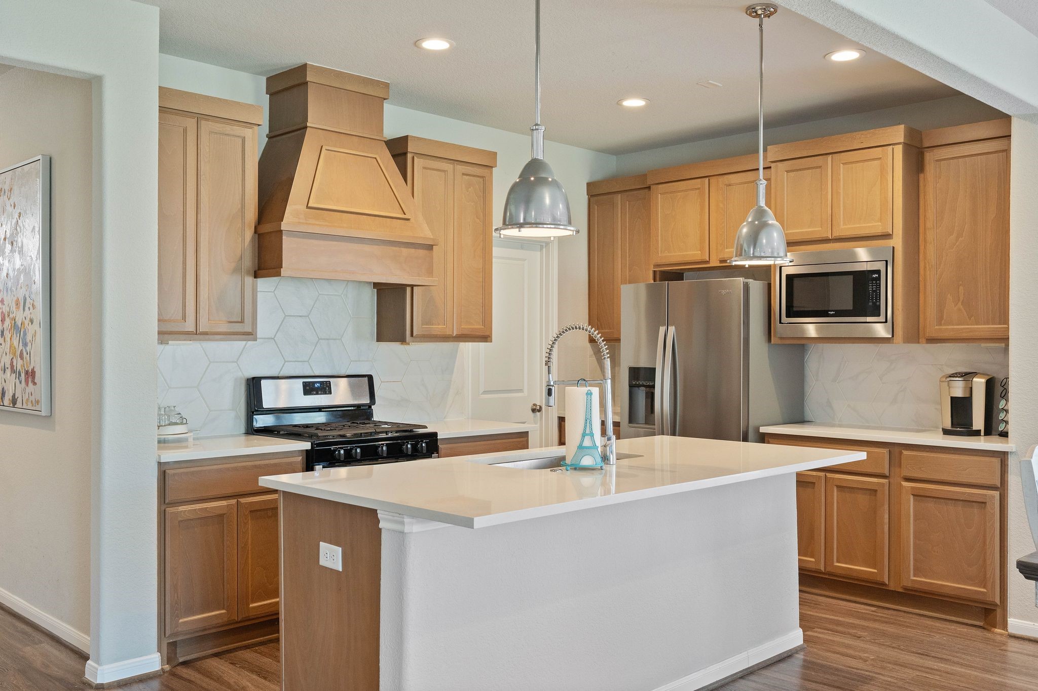 2328 Hagerman Road Conroe, TX 77384 - Photo 20 of 45 a kitchen with kitchen island a sink appliances and cabinets