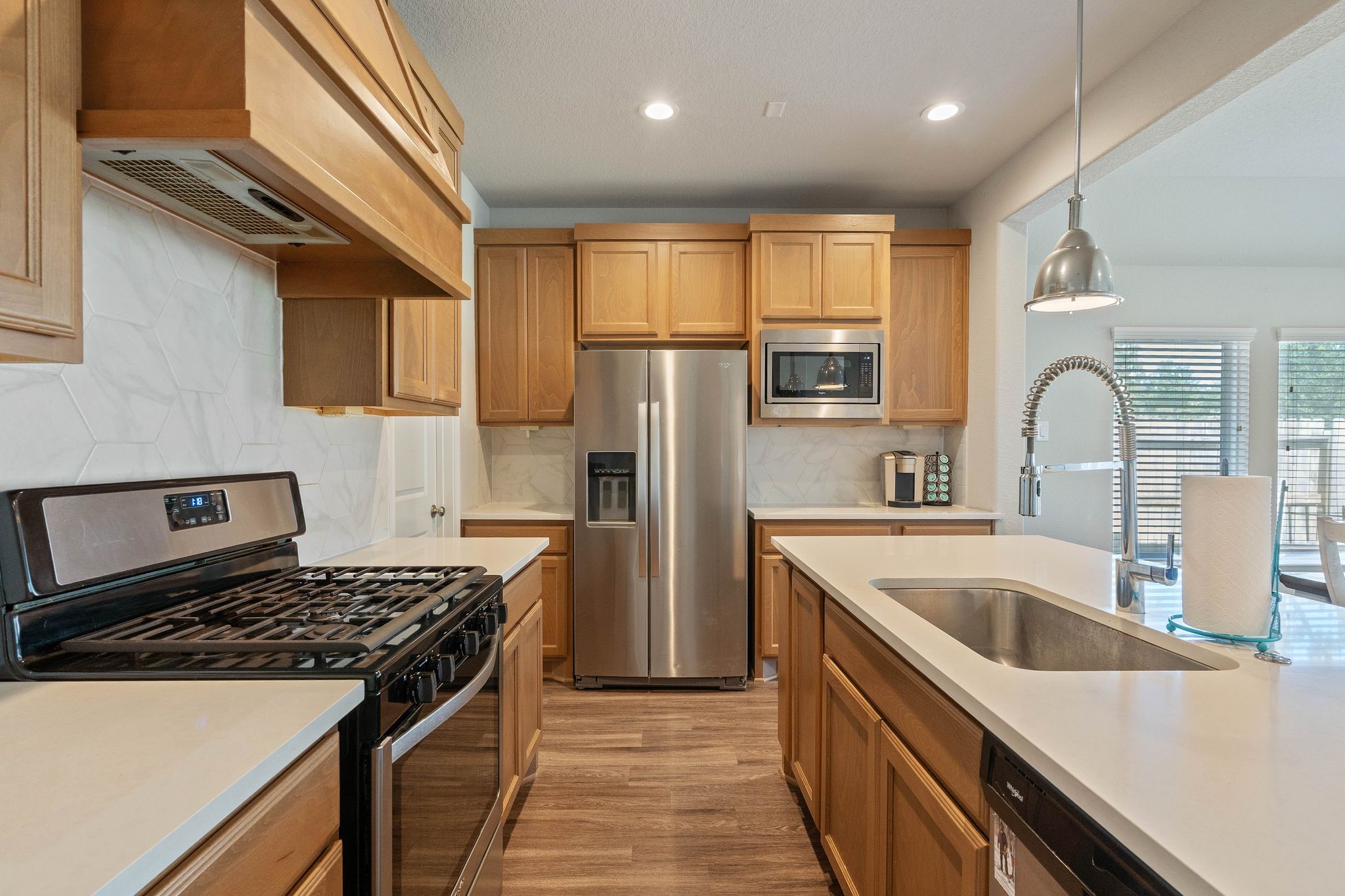 2328 Hagerman Road Conroe, TX 77384 - Photo 21 of 45 a kitchen with stainless steel appliances granite countertop a sink stove and refrigerator