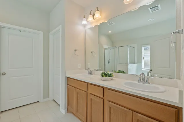 a bathroom with a sink double vanity and a mirror