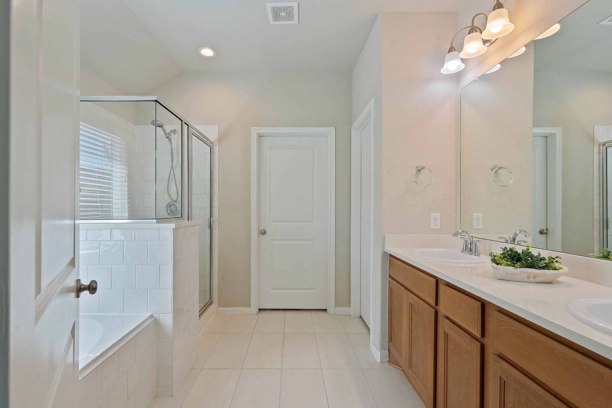 2328 Hagerman Road Conroe, TX 77384 - Photo 25 of 45 a bathroom with a double vanity sink and mirror