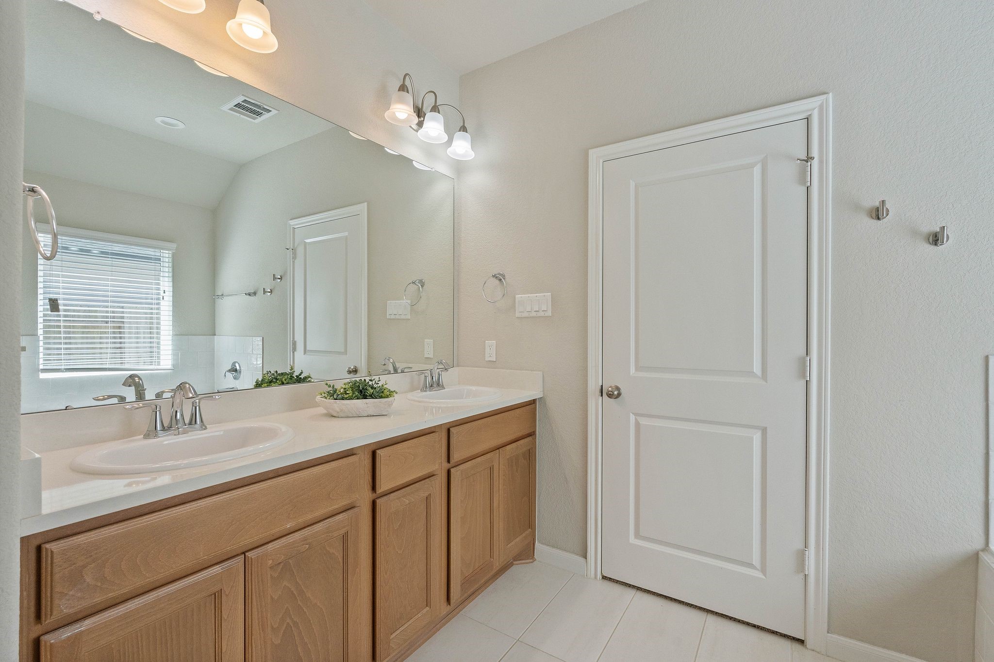 2328 Hagerman Road Conroe, TX 77384 - Photo 27 of 45 a bathroom with a double vanity sink and a mirror