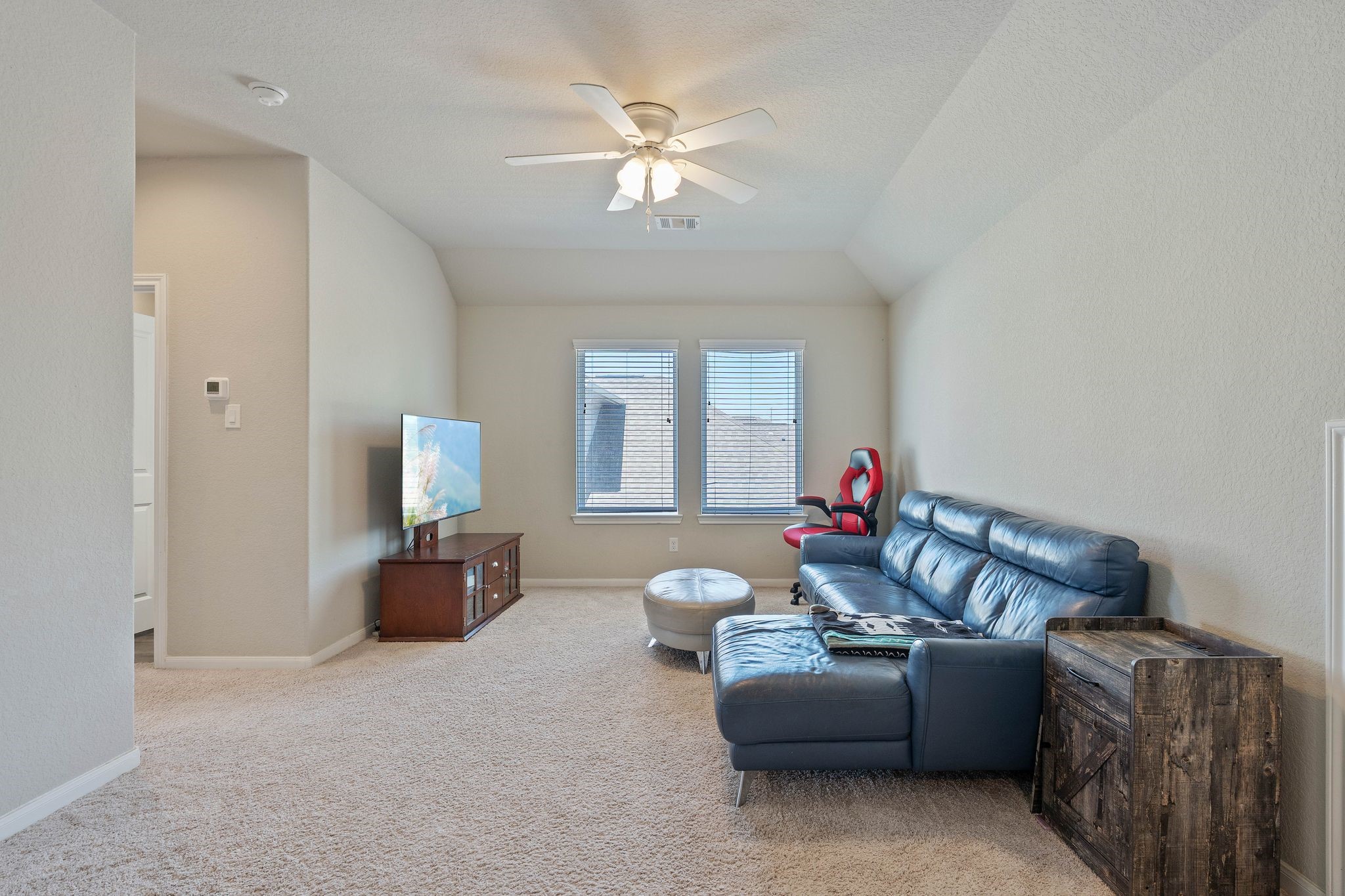 2328 Hagerman Road Conroe, TX 77384 - Photo 29 of 45 a living room with furniture and a chandelier