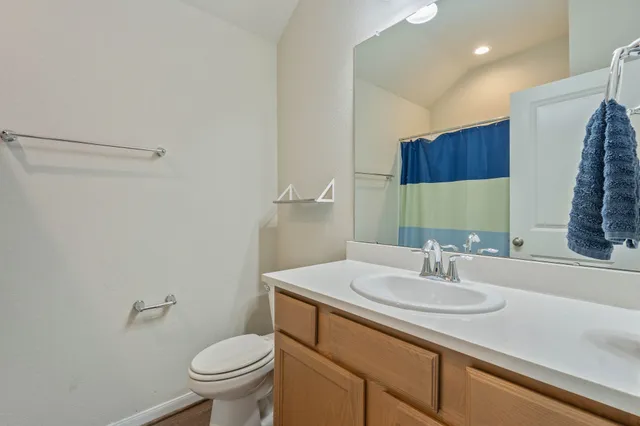 a bathroom with a sink toilet and a mirror