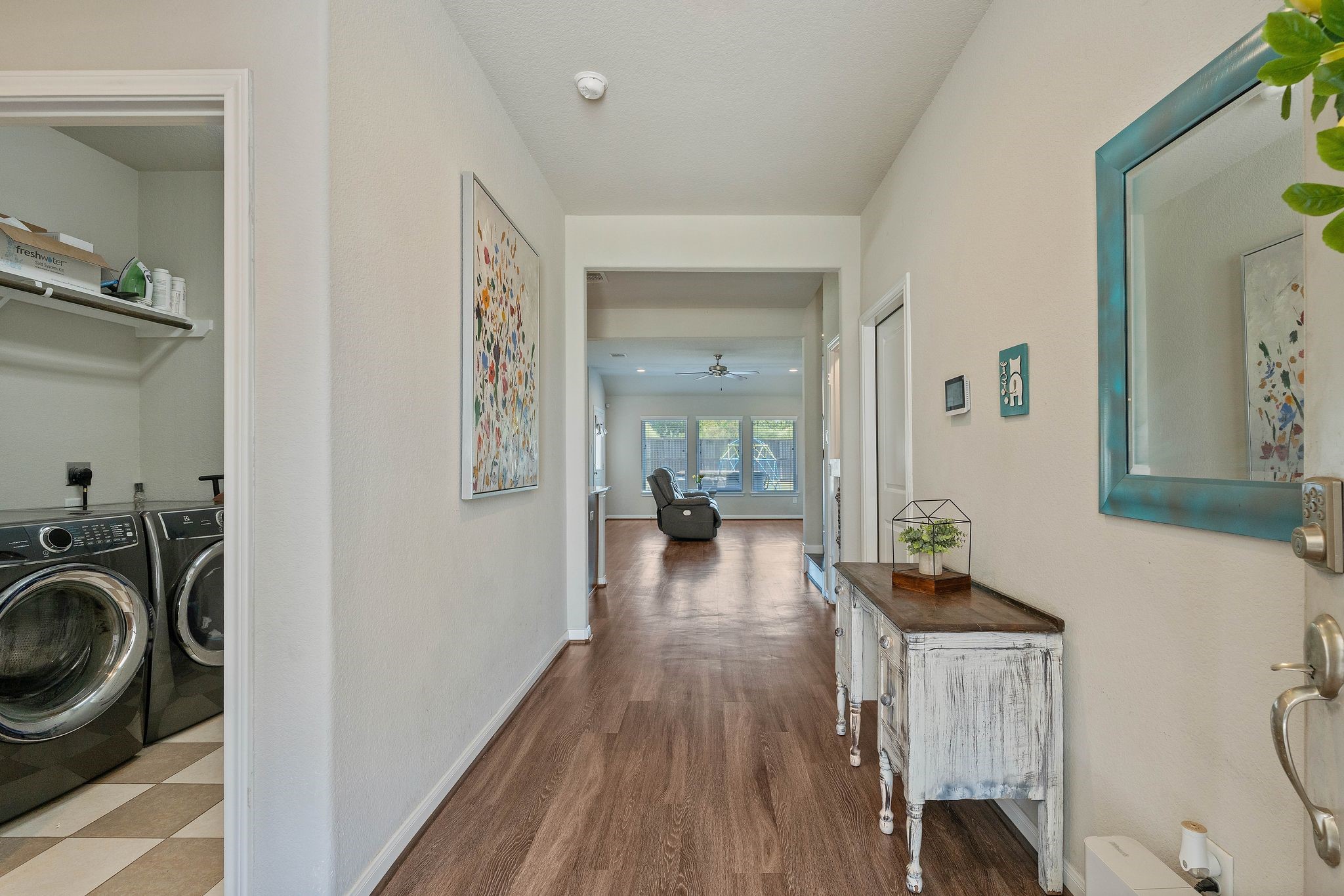 2328 Hagerman Road Conroe, TX 77384 - Photo 8 of 45 a view of a hallway and a livingroom with furniture wooden floor