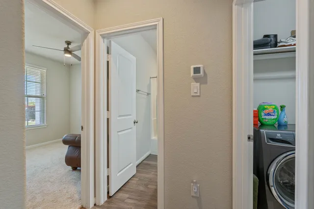 a view of a hallway with washer and dryer