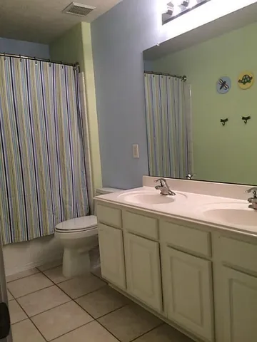 a bathroom with a double vanity sink and mirror