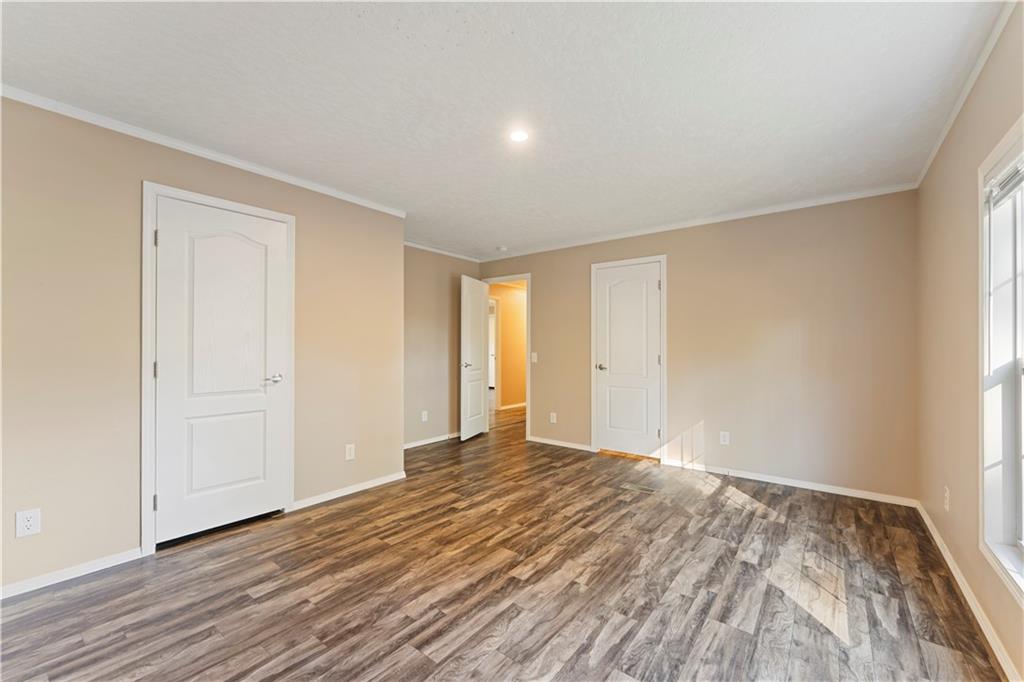 89 Ridge Road Seale, AL 36875 - Photo 34 of 46 Neutral-toned walls complement wood-finish flooring