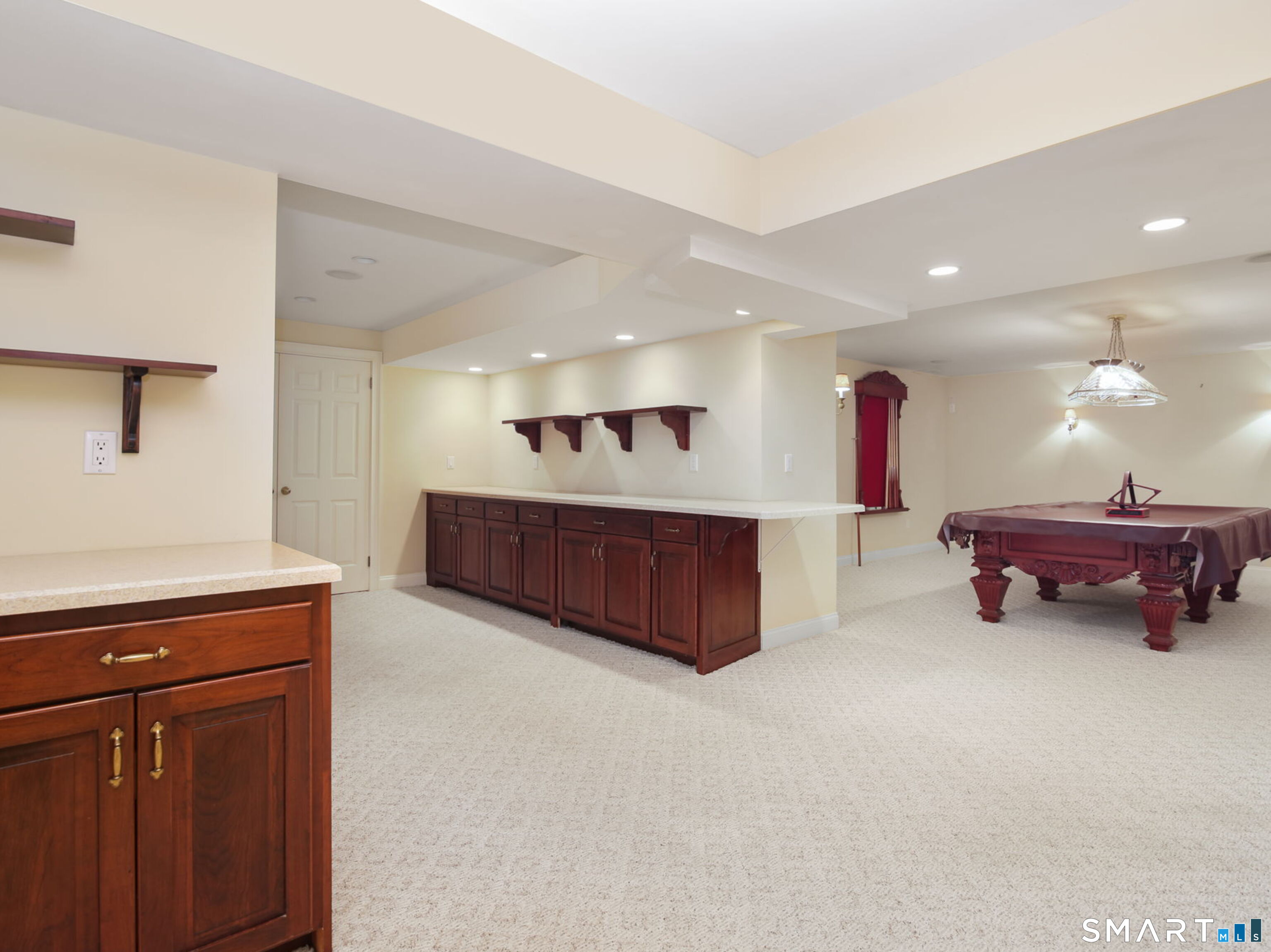 Generous finished lower-level recreation space ideal for billiards, game nights, or entertaining