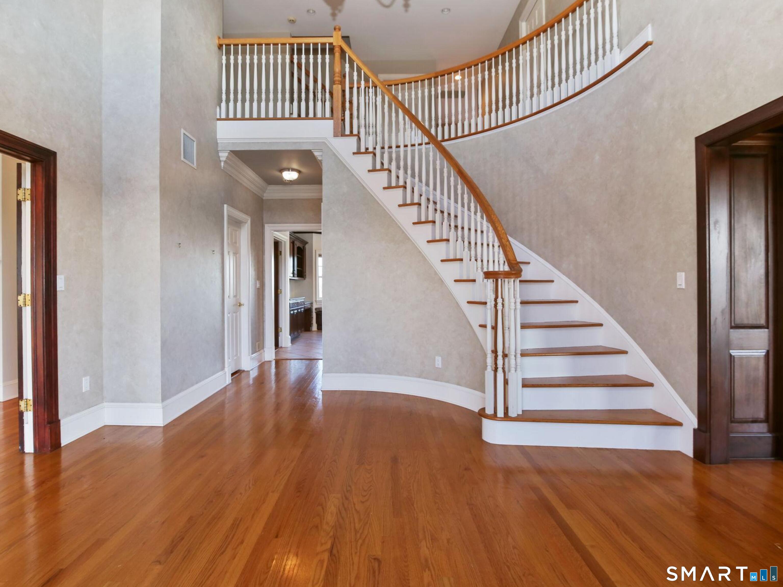 7 Long Meadow Lane Redding, CT 06896 - Photo 17 of 38 Welcome to 7 Long Meadow with an impressive two-story entry with curved staircase and hardwood floors