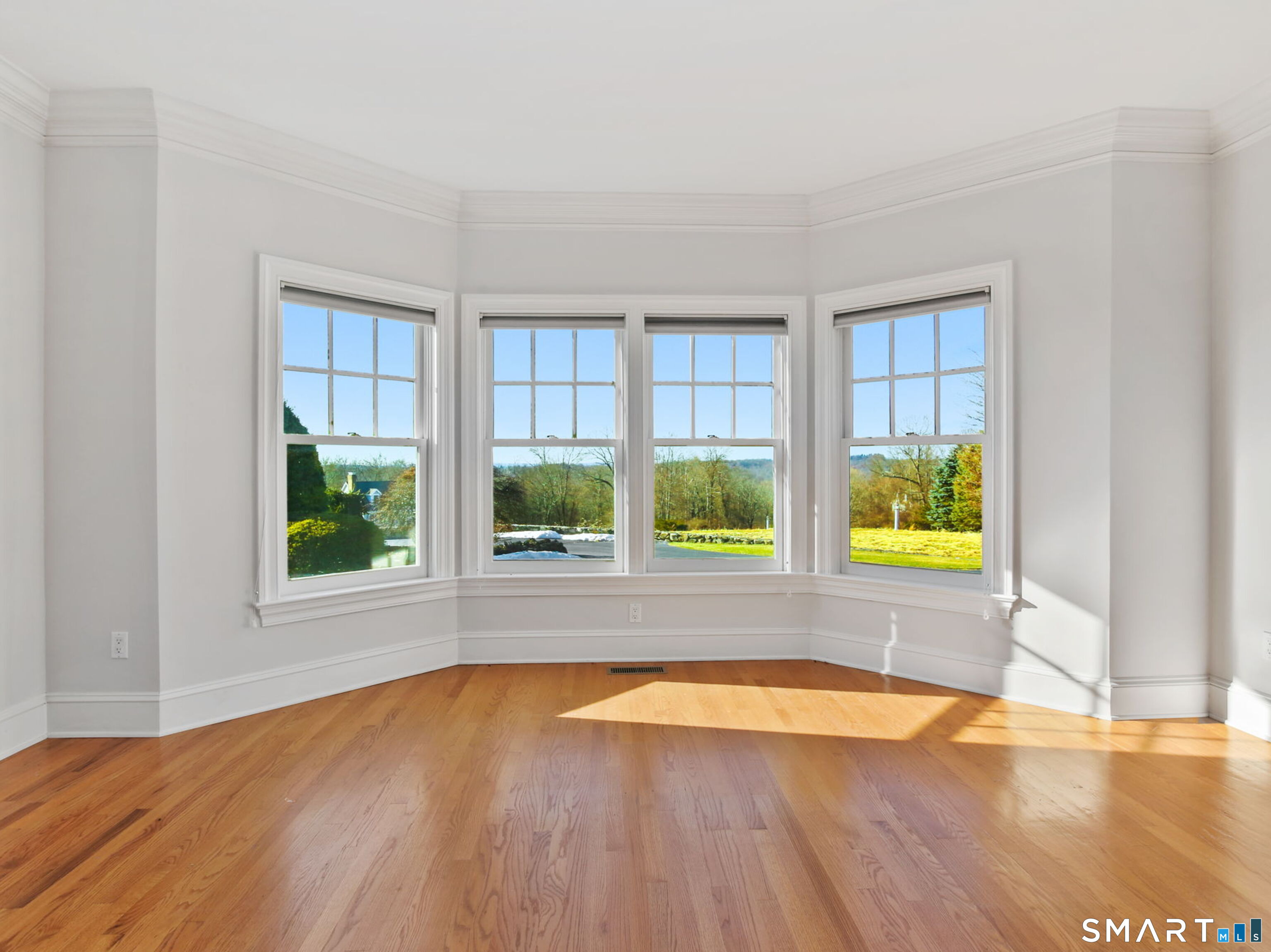 7 Long Meadow Lane Redding, CT 06896 - Photo 18 of 38 Living room with beautiful bay windows bring in abundant natural light and scenic outdoor views