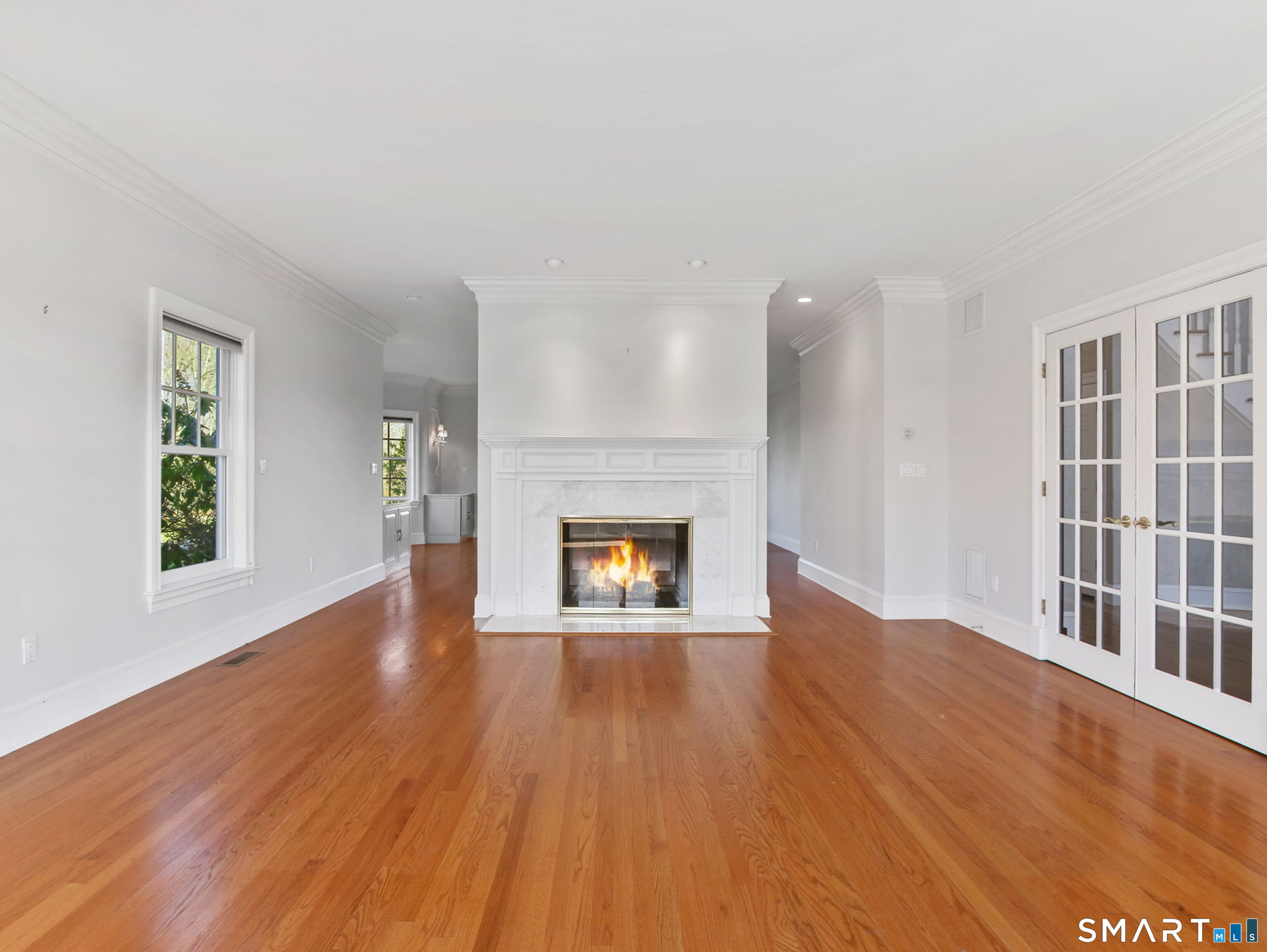 7 Long Meadow Lane Redding, CT 06896 - Photo 21 of 38 Gas front to back fireplace and classic millwork serves as a focal point of the living and dining space