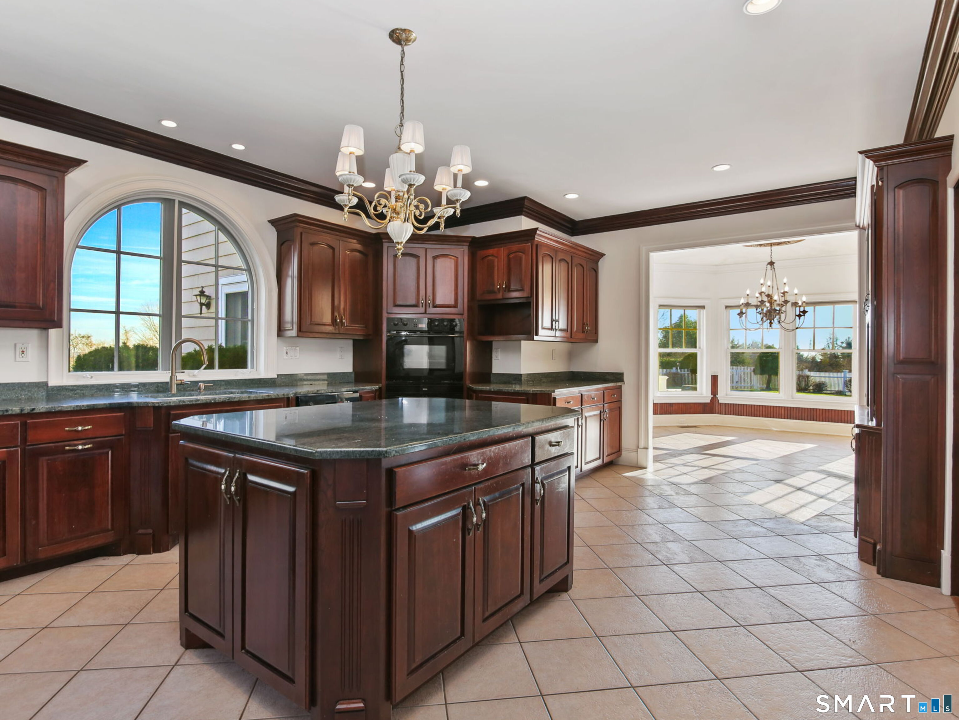 7 Long Meadow Lane Redding, CT 06896 - Photo 24 of 38 Kitchen sink set beneath an arched window with peaceful backyard views
