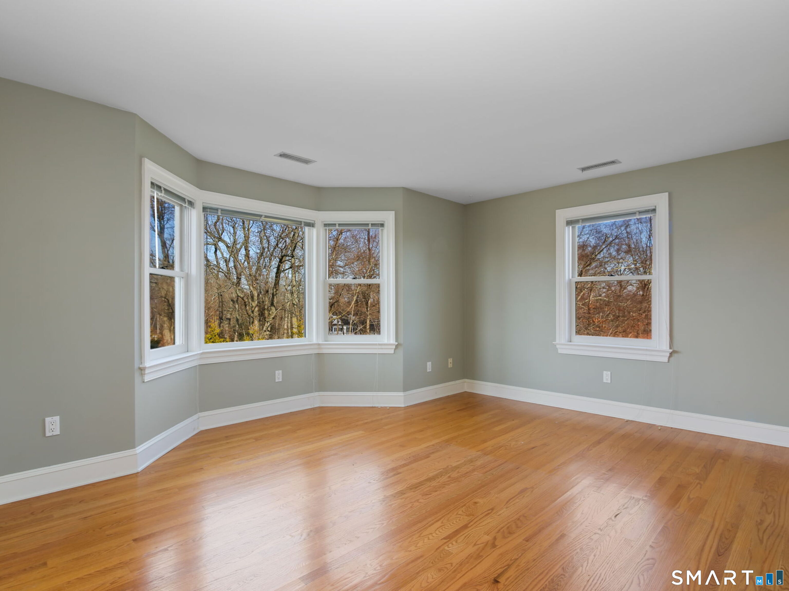 7 Long Meadow Lane Redding, CT 06896 - Photo 25 of 38 a view of an empty room with wooden floor and a window