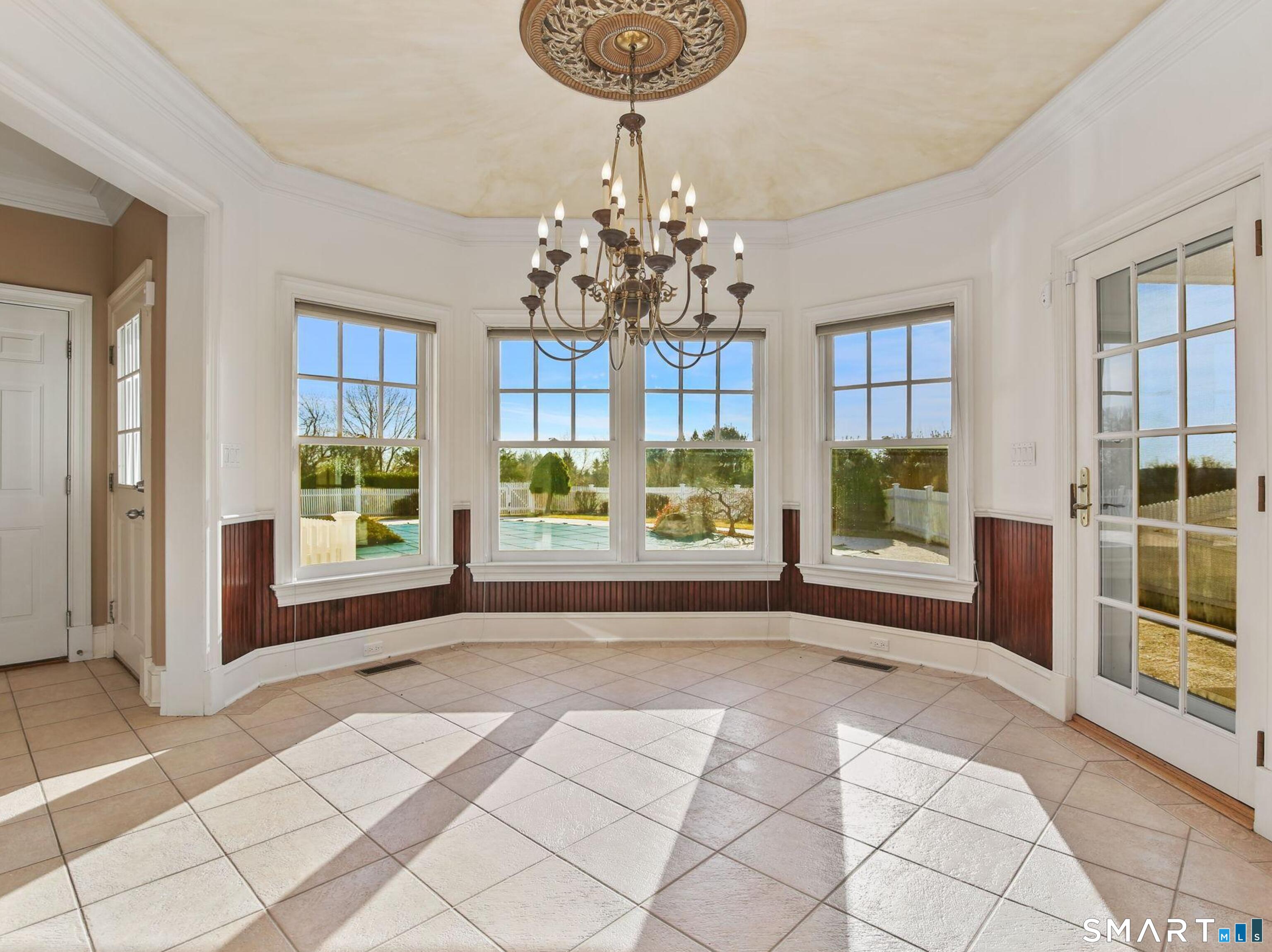 7 Long Meadow Lane Redding, CT 06896 - Photo 26 of 38 Sun-filled dining space with multiple windows and French door access to the exterior patio and pool