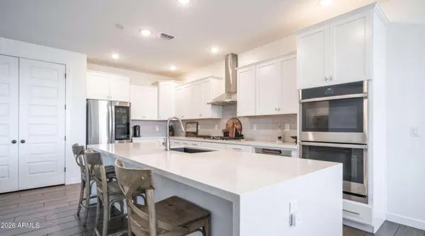 a kitchen with a stove a sink and a refrigerator