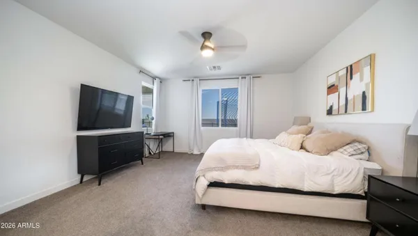 a en suite bathroom with a shower sink and mirror
