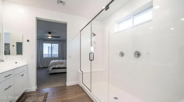 a spacious bathroom with a double vanity sink and a mirror