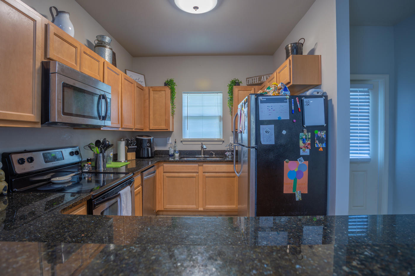 40 Myrtle Oak Way Santa Rosa Beach, FL 32459 - Photo 8 of 42 a kitchen with stainless steel appliances granite countertop a refrigerator a stove and a sink with wooden floor