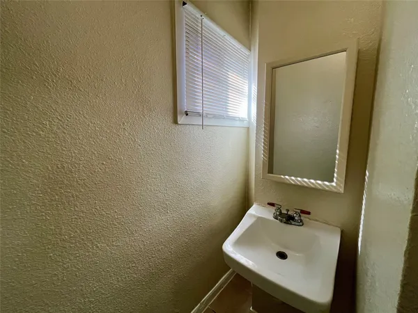 a bathroom with a sink and a window