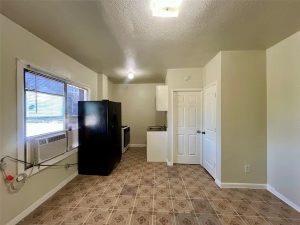 a kitchen with a refrigerator and a sink