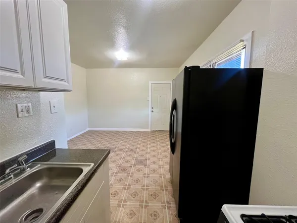 a kitchen with a sink and a refrigerator