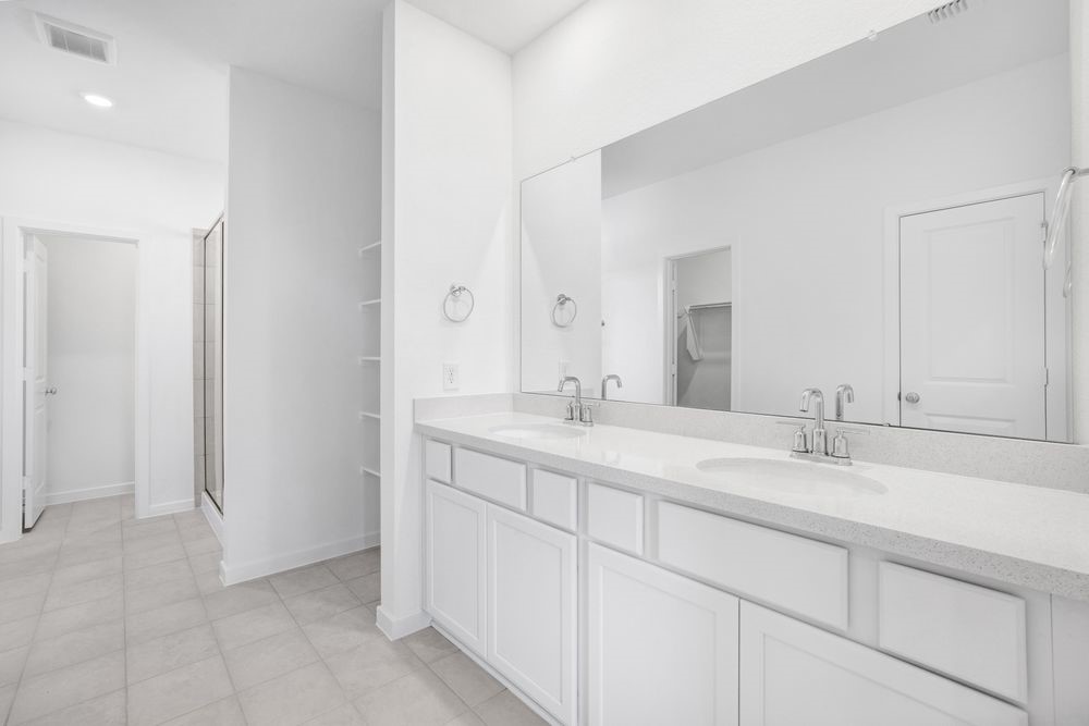 22122 Strathfield Circle Cypress, TX 77433 - Photo 14 of 38 a bathroom with a sink and a mirror