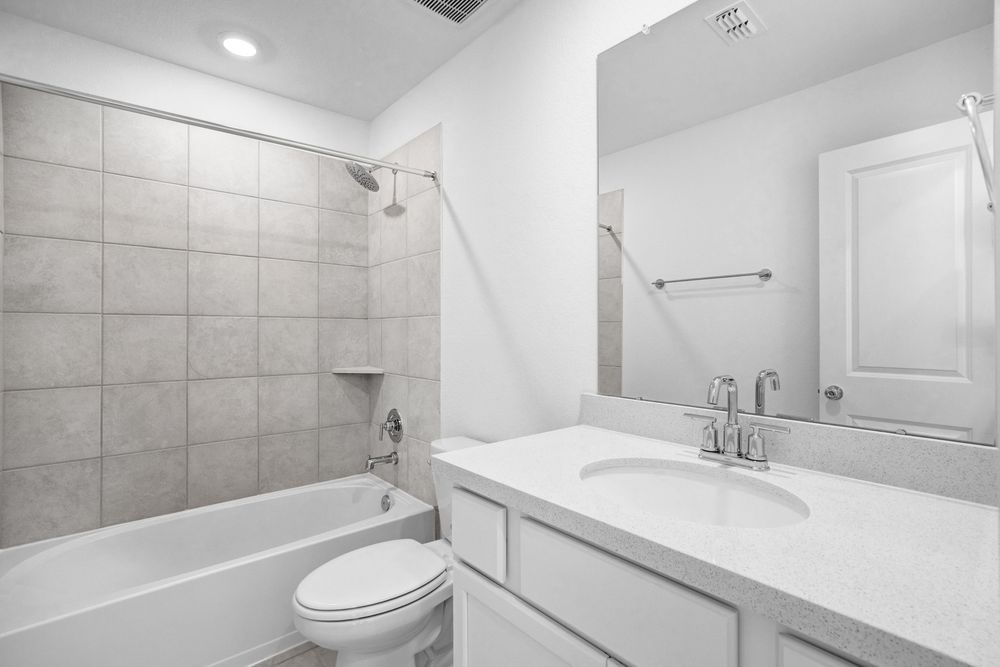 22122 Strathfield Circle Cypress, TX 77433 - Photo 18 of 38 a bathroom with a sink a toilet and a bathtub