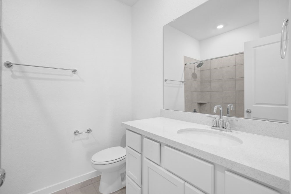 22122 Strathfield Circle Cypress, TX 77433 - Photo 19 of 38 a bathroom with a sink a toilet and shower