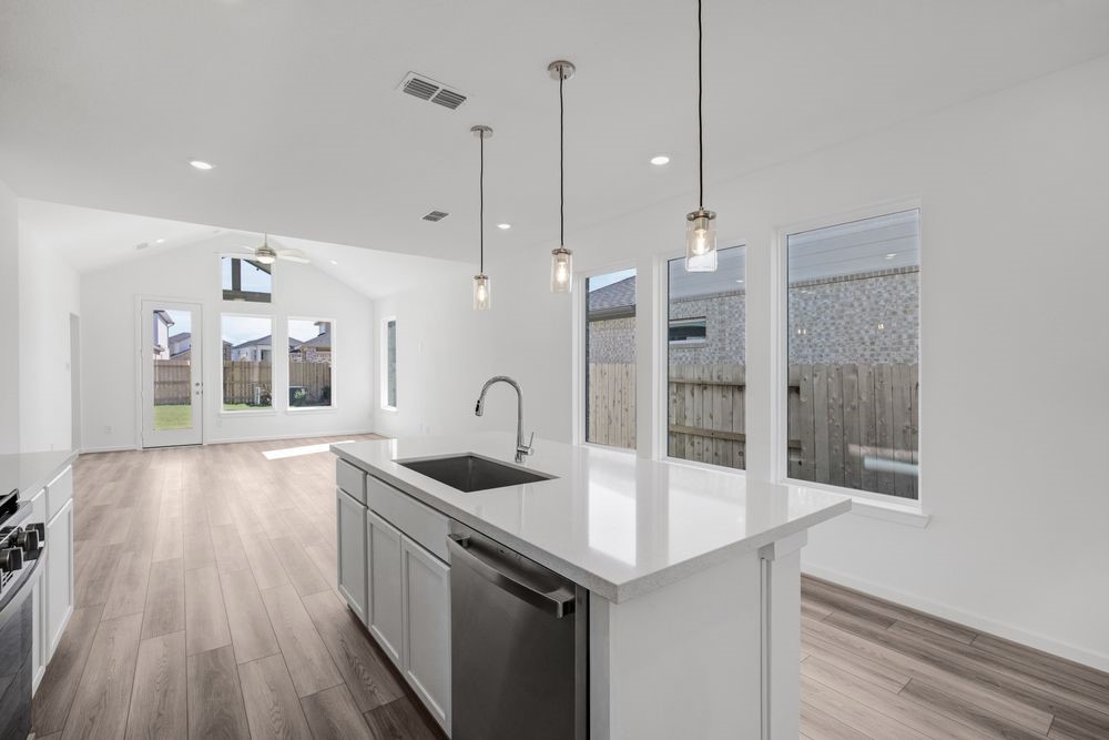 22122 Strathfield Circle Cypress, TX 77433 - Photo 3 of 38 a kitchen with stainless steel appliances granite countertop a sink a oven a counter space and cabinets