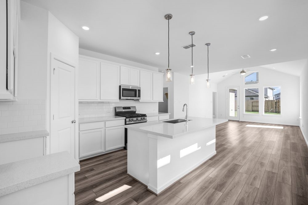 22122 Strathfield Circle Cypress, TX 77433 - Photo 6 of 38 a large white kitchen with stainless steel appliances