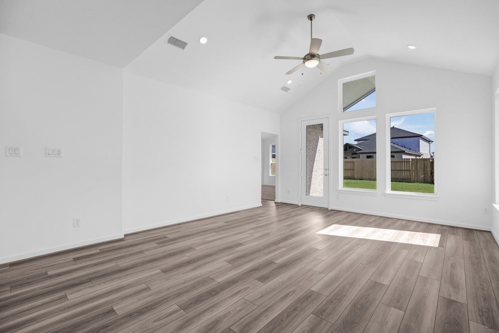 22122 Strathfield Circle Cypress, TX 77433 - Photo 7 of 38 wooden floor in an empty room with a window