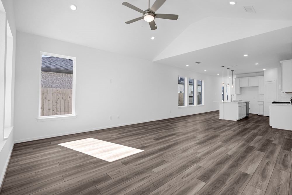 22122 Strathfield Circle Cypress, TX 77433 - Photo 9 of 38 a view of empty room with wooden floor and windows