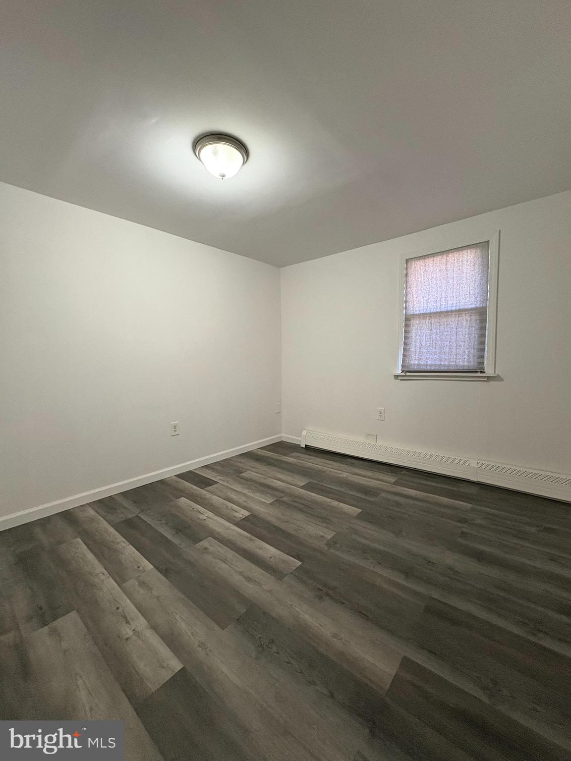 38 Broadway, Unit D Laurel Springs, NJ 08021 - Photo 15 of 21 an empty room with wooden floor and windows