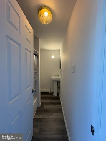 a view of a hallway with wooden floor and a staircase
