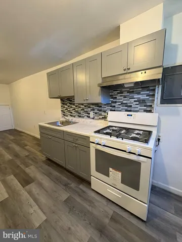 a kitchen with a stove and a sink