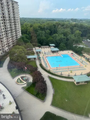 a view of a swimming pool with a yard