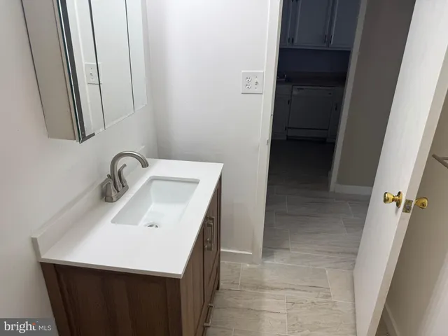 a utility room with sink dryer and washer