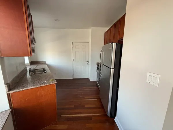 a kitchen with metallic refrigerator and stove